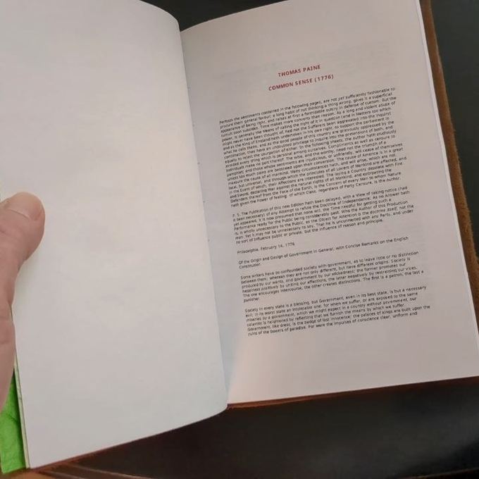 Open book with a hand-dyed green fore-edge, text visible on the page