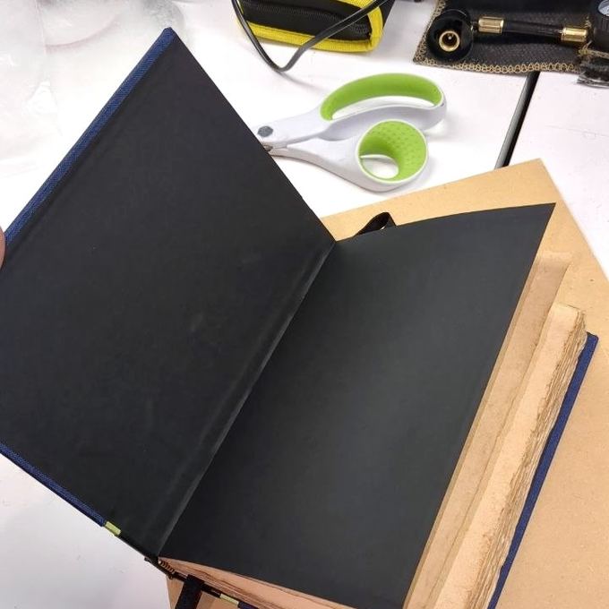 Deckled fore-edge on a navy cased book, ready to trim