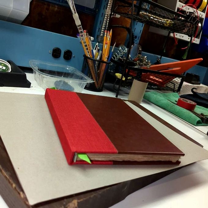 Finished quarter-bound book, red cloth and leather